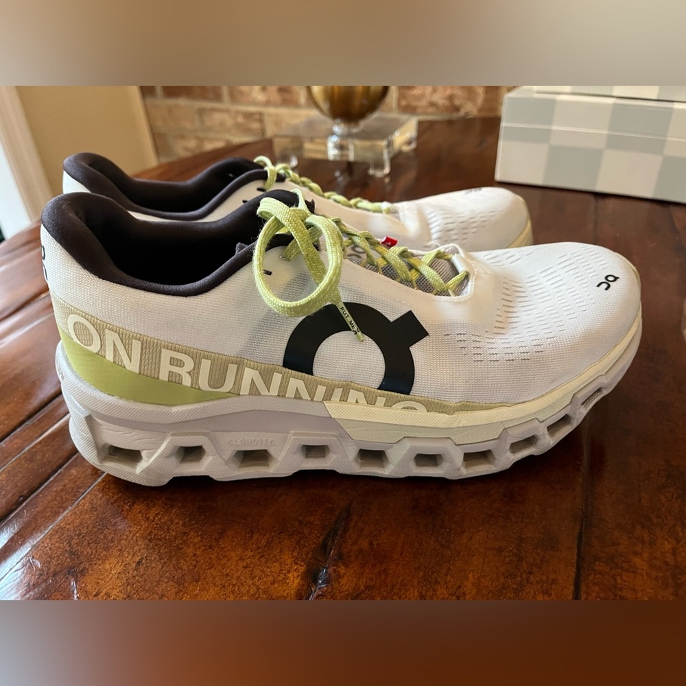On Running White and Green Athletic Shoes